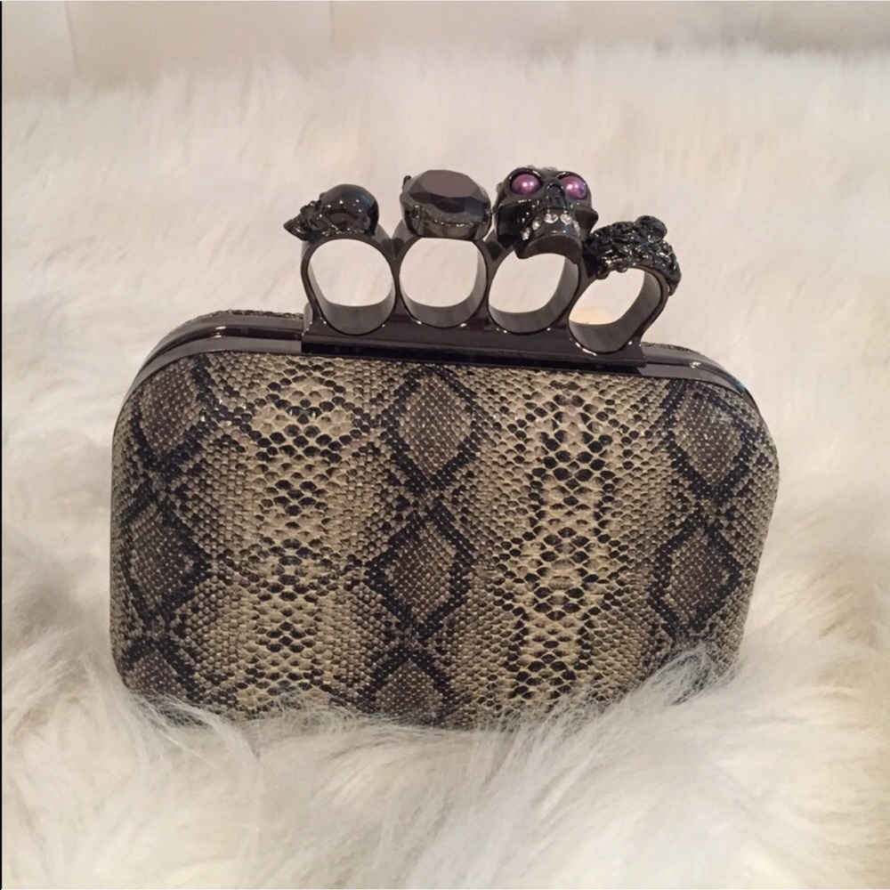 Faux snakeskin clutch with jewel and skull design